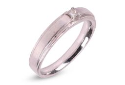 A diamond-set ring, featuring a central claw-set princess-cut diamond of estimated 0.09ct, to a tape