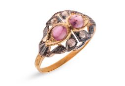 A ruby cabochon and rose-cut diamond dress ring in gilt metal, the openwork mount centred with two r