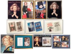 A group of promotional posters and a large signed photograph