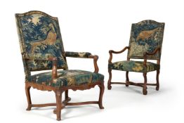 A MATCHED PAIR OF WALNUT AND VERDURE TAPESTRY UPHOLSTERED ARMCHAIRS, FRENCH, EARLY 18TH CENTURY