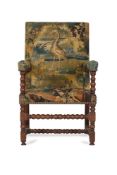 A WALNUT AND VERDURE TAPESTRY UPHOLSTERED ARMCHAIR, 18TH CENTURY