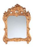 A CONTINENTAL CARVED GILTWOOD MIRROR, 19TH CENTURY