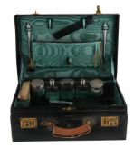A LEATHER TRAVEL CASE WITH A SILVER MOUNTED DRESSING TABLE SET