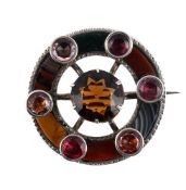 SCOTTISH INTEREST: A VICTORIAN HARDSTONE, CAIRNGORM AND FOILED STONE CIRCULAR BROOCH