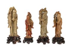 FOUR CARVED SOAP STONE FIGURES OF IMMORTALS ON BASES, EARLY 20TH CENTURY