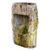 A CARVED AND PART POLISHED PETRIFIED WOOD SINK OR FOUNTAIN BASE