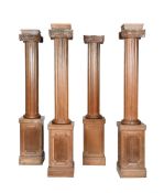A SET OF FOUR FREESTANDING CARVED OAK IONIC COLUMNS, 20TH CENTURY