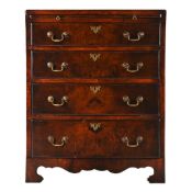 A WALNUT AND CROSSBANDED BOWFRONT BACHELOR'S CHEST OF DRAWERS, CIRCA 1740 AND LATER