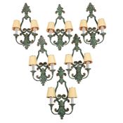 A SET OF SIX GREEN PATINATED TWO-LIGHT METAL WALL LIGHTS, OF RECENT MANUFACTURE