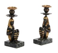 A PAIR OF EGYPTIAN REVIVAL BRONZE AND PARCEL GILT CANDLESTICKS, 20TH CENTURY