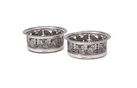 A PAIR OF GEORGE III SILVER BOTTLE COASTERS