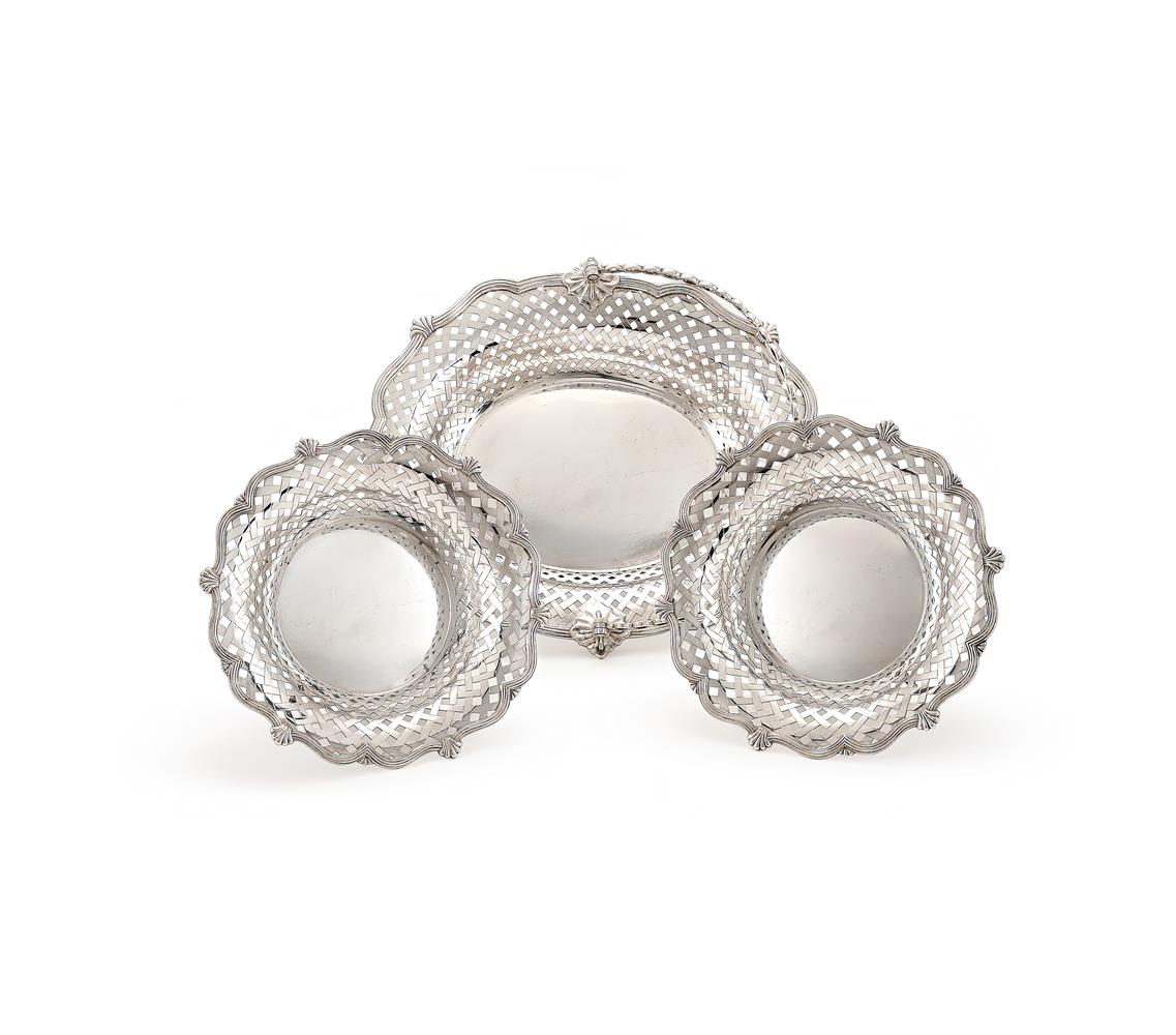AN EDWARDIAN SILVER SWING HANDLED SHAPED OVAL BASKET AND TWO BOWLS