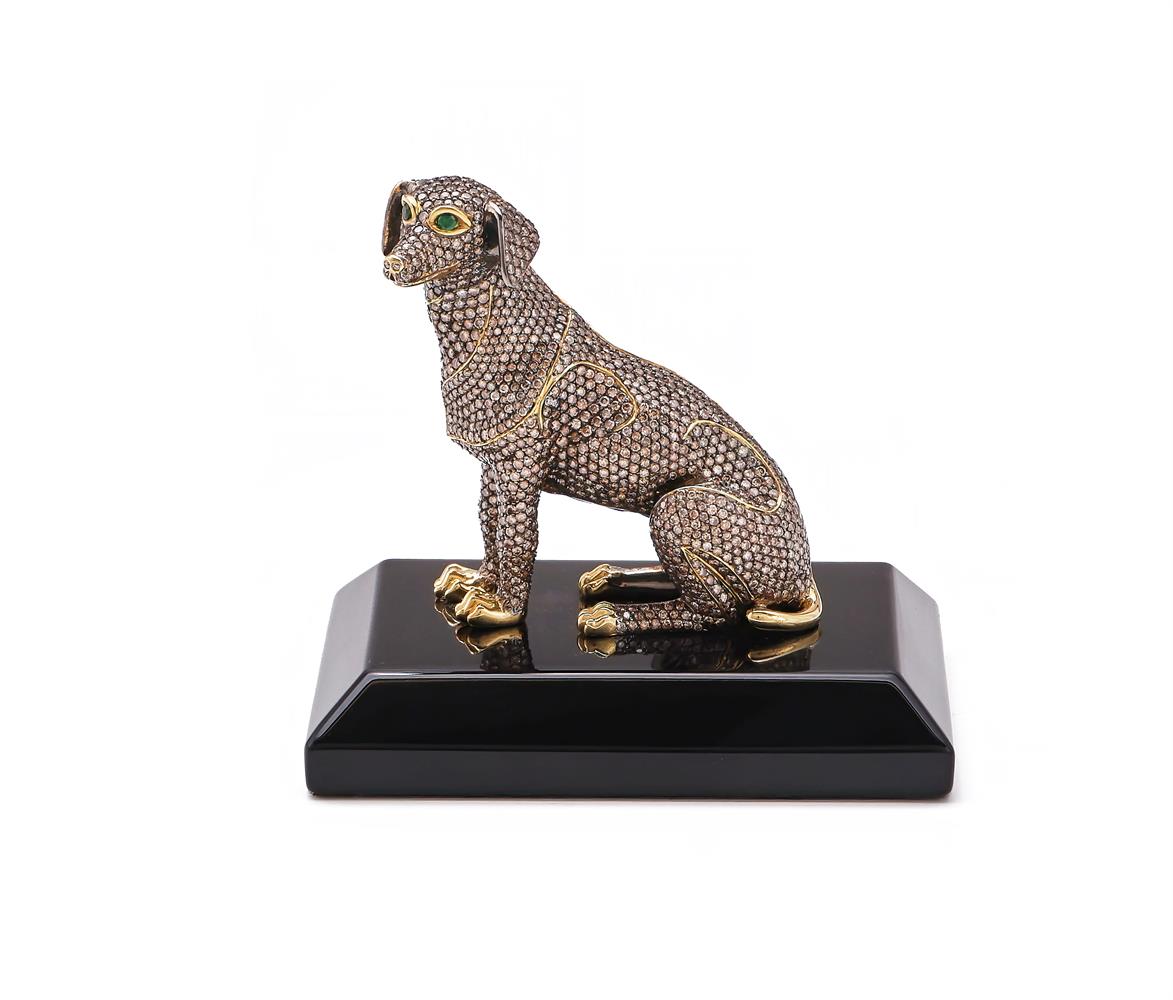 A GOLD COLOURED AND DIAMOND SET MODEL OF A DOG