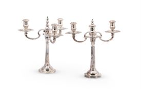 A PAIR OF SILVER CANDLESTICKS WITH ASSOCIATED THREE LIGHT BRANCHES