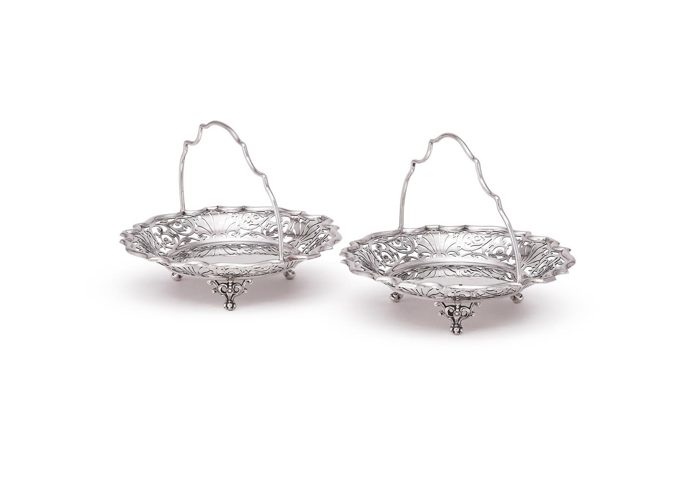A PAIR OF EDWARDIAN SILVER SHAPED CIRCULAR BASKETS
