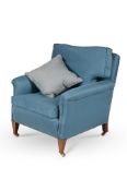 A MAHOGANY AND BLUE UPHOLSTERED ARMCHAIR, IN THE MANNER OF HOWARD & SONS, EARLY 20TH CENTURY