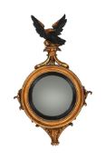 A GEORGE IV GILTWOOD AND EBONISED CONVEX WALL MIRROR, CIRCA 1830