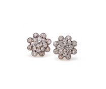 A PAIR OF EDWARDIAN DIAMOND SET FLOWER HEAD EARRINGS