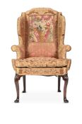 A QUEEN ANNE WALNUT WING ARMCHAIR, CIRCA 1710