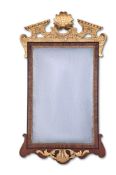 A GEORGE II FIGURED WALNUT AND PARCEL GILT MIRROR, CIRCA 1740