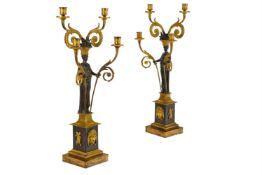 A PAIR OF FRENCH PATINATED AND GILT BRONZE FOUR LIGHT CANDELABRA IN THE MANNER OF FRANÇOIS RÉMOND
