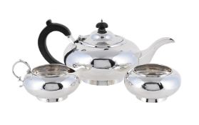 A SILVER THREE PIECE CIRCULAR TEA SET