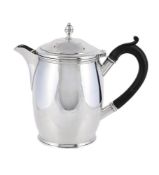 A SILVER BARREL SHAPED HOT WATER JUG