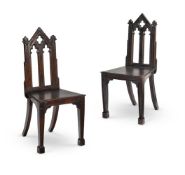 A PAIR OF GOTHIC CARVED OAK HALL CHAIRS, 19TH CENTURY