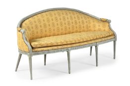 A GEORGE III CARVED, CREAM PAINTED AND UPHOLSTERED SOFA, IN THE MANNER OF JOHN LINNELL, CIRCA 1790