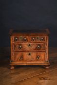 A FINE WILLIAM & MARY BURR WALNUT AND FEATHERBANDED MINIATURE CHEST OF DRAWERS, CIRCA 1690