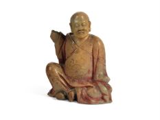 A CHINESE CARVED SOAPSTONE 'ENLIGHTENED SACRED FIGURE', PROBABLY 18TH CENTURY