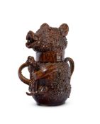 AN ENGLISH TREACLE-GLAZED STONEWARE BEAR BAITING JUG AND COVER, MID 18TH CENTURY