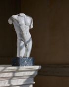 AFTER THE ANTIQUE, A CARVED MARBLE MALE TORSO, IN ANCIENT ROMAN STYLE, 19TH OR 20TH CENTURY