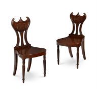 A PAIR OF GEORGE III CARVED MAHOGANY HALL CHAIRS, IN THE MANNER OF GILLOWS, CIRCA 1800