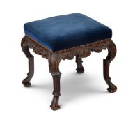 AN UNUSUAL CARVED OAK STOOL, IN THE MANNER OF WILLIAM KENT, EARLY 18TH CENTURY