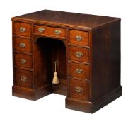 A GEORGE III OAK KNEEHOLE DESK OR DRESSING TABLE, LATE 18TH CENTURY