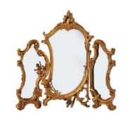 A GILTWOOD TRI-FOLD DRESSING TABLE MIRROR IN BAROQUE STYLE