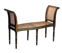 AN EBONISED AND PARCEL GILT WINDOW SEAT IN REGENCY STYLE, MID 20TH CENTURY