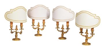 A GROUP OF FOUR TWO LIGHT GILT METAL TABLE LAMPS, IN LOUIS XV ROCAILLE STYLE, 20TH CENTURY