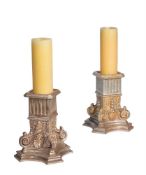 A PAIR OF CANDLESTICKS IN THE FORM OF OVERSIZED INVERTED COLUMN CAPITALS, OF RECENT MANUFACTURE