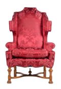 A WALNUT AND UPHOLSTERED WING ARMCHAIR, IN WILLIAM AND MARY STYLE, 20TH CENTURY