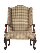 A MAHOGANY AND UPHOLSTERED WING ARMCHAIR, IN GEORGE III STYLE, LATE 19TH OR EARLY 20TH CENTURY