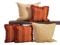 A GROUP OF FIVE CREAM AND RED CUSHIONS, OF RECENT MANUFACTURE