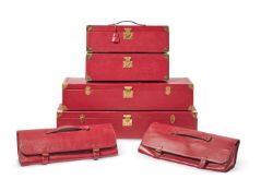 A SEVEN PIECE SET OF RED LEATHER LUGGAGE, MODERN
