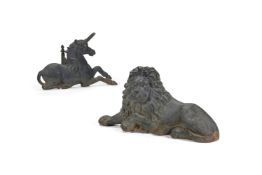 A PAIR OF VICTORIAN BLACK PAINTED CAST IRON LION AND UNICORN FIRE DOGS