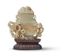 A Chinese celadon and russet jade vase and cover