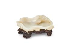 A Chinese pale celadon jade 'Lotus and dragon' washer