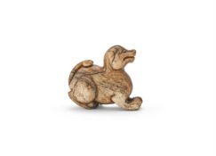 A Chinese brown jade carving of a dog