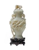 A Chinese pale celadon or white jade vase and cover