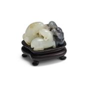 A Chinese black and white jade 'three rams' carving